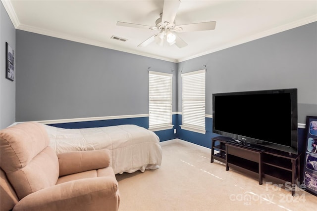 carpeted bedroom with ceiling fan and crown molding