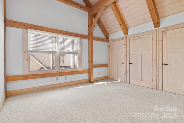 interior space featuring vaulted ceiling with beams and light colored carpet