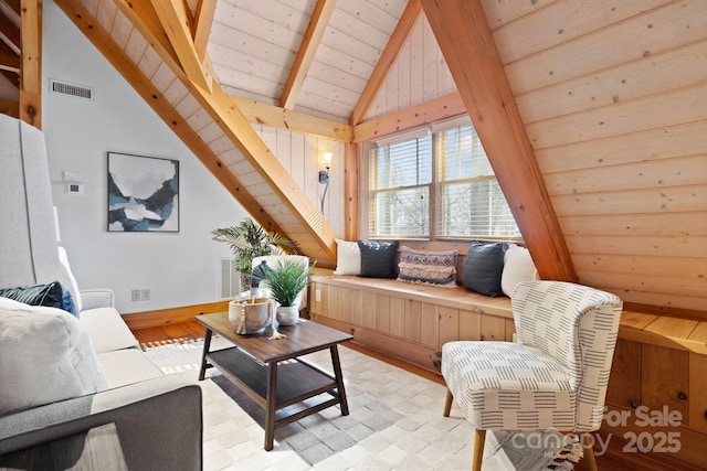 living room with lofted ceiling with beams, wood ceiling, and light hardwood / wood-style flooring