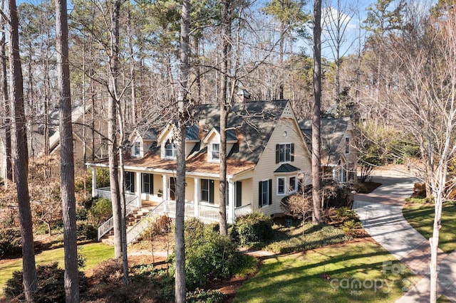 view of front of property with a front yard and a porch