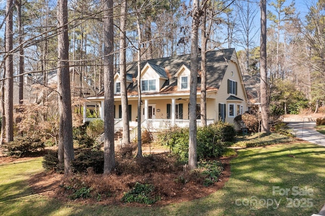 cape cod-style house featuring a porch and a front yard