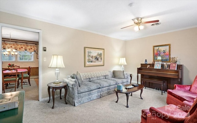 living room with ceiling fan with notable chandelier, light colored carpet, and ornamental molding