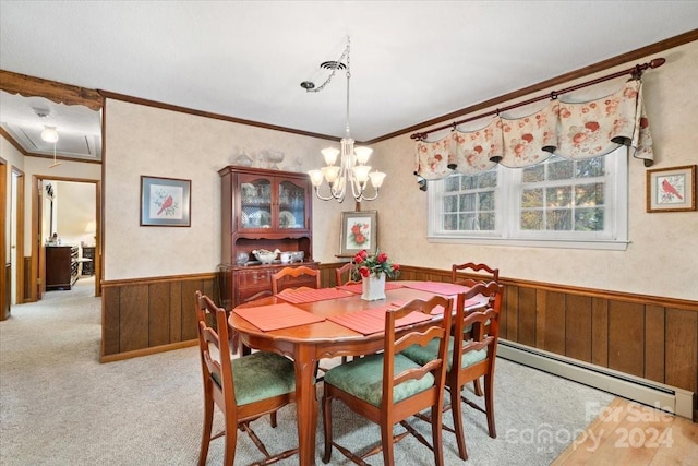 dining area featuring light colored carpet, wooden walls, crown molding, a baseboard heating unit, and a chandelier