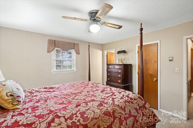 carpeted bedroom with a textured ceiling and ceiling fan