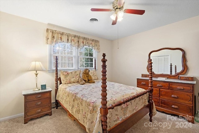 bedroom with ceiling fan, baseboard heating, and light carpet