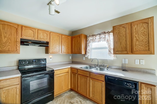 kitchen with black appliances, sink, and rail lighting