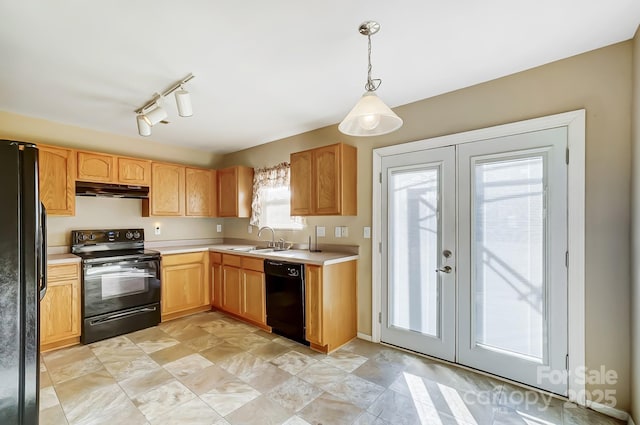 kitchen with black appliances, pendant lighting, sink, and french doors