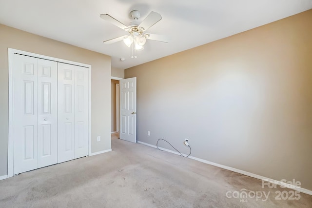 unfurnished bedroom featuring ceiling fan, a closet, and light colored carpet