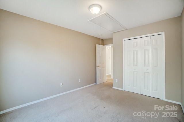 unfurnished bedroom featuring light carpet and a closet