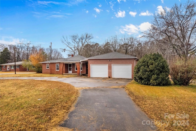 ranch-style home with a front lawn and a garage