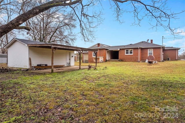 back of house featuring a yard and a patio area