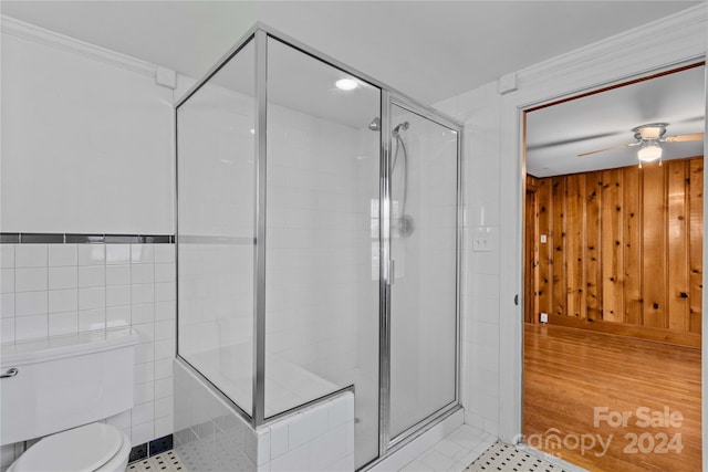 bathroom with tile patterned flooring, toilet, ceiling fan, and a shower with shower door