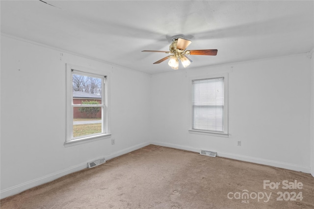 carpeted spare room with ceiling fan