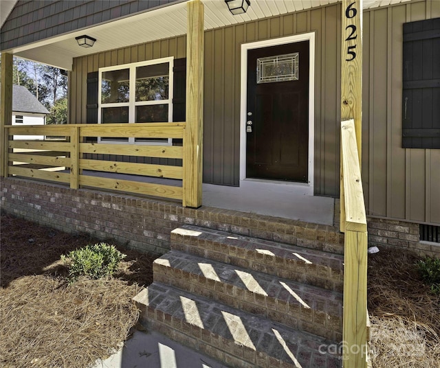 property entrance featuring board and batten siding