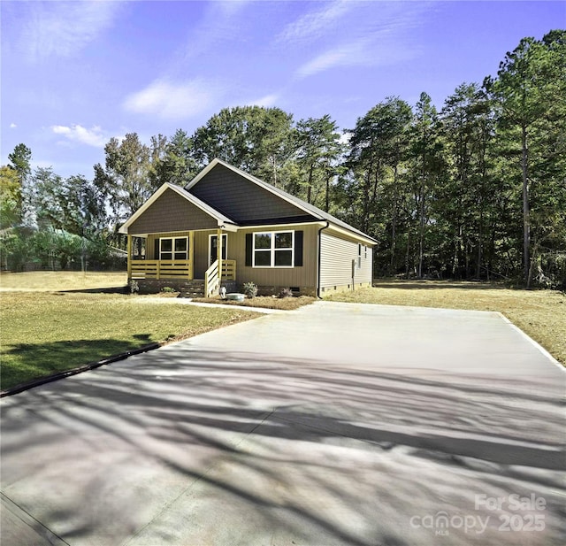 view of front of house with concrete driveway, a front lawn, and crawl space