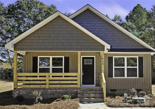 view of front of home featuring board and batten siding, entry steps, and crawl space