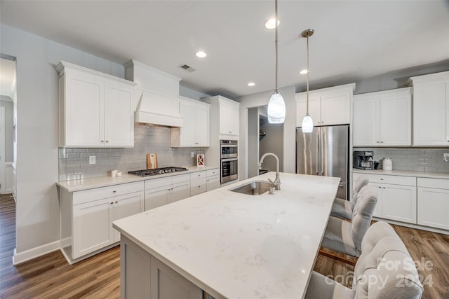 kitchen with dark hardwood / wood-style flooring, sink, stainless steel appliances, and decorative light fixtures