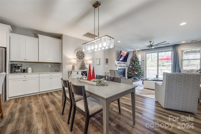 dining area with ceiling fan and dark hardwood / wood-style flooring