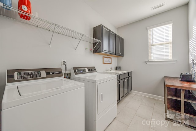 laundry room with cabinets, separate washer and dryer, sink, and light tile patterned floors