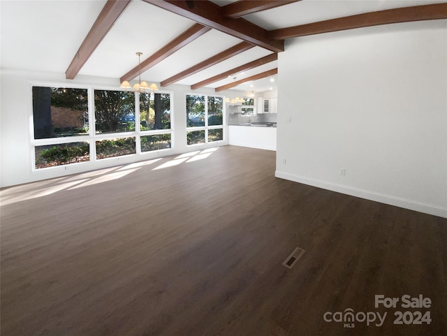 unfurnished living room with vaulted ceiling with beams, dark wood-type flooring, and a notable chandelier