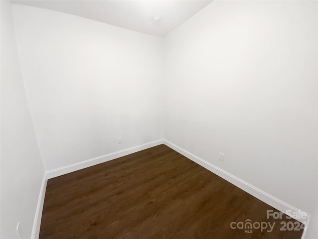 spare room with dark wood-type flooring