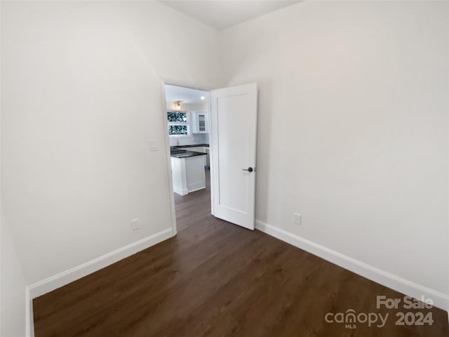 unfurnished room featuring dark hardwood / wood-style flooring