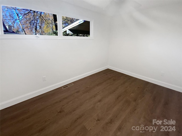 spare room featuring dark wood-type flooring