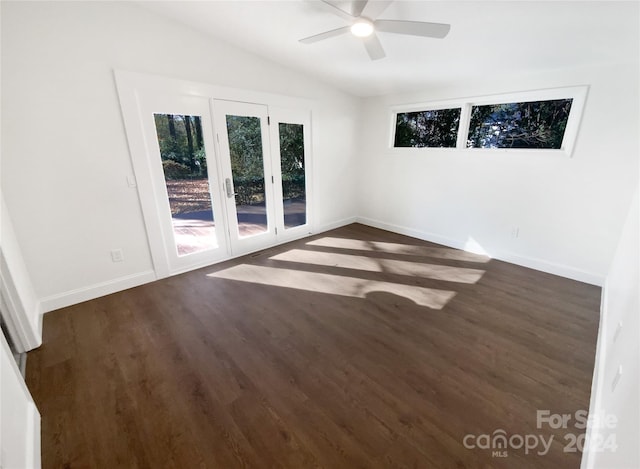 unfurnished room featuring dark hardwood / wood-style flooring, vaulted ceiling, and ceiling fan