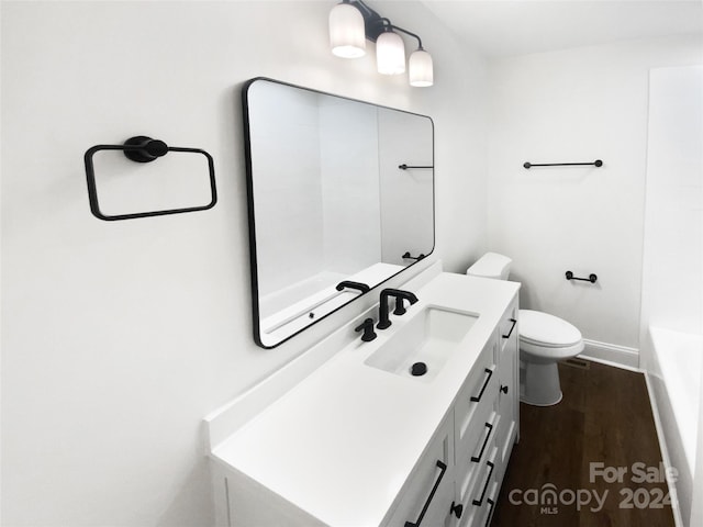 bathroom with hardwood / wood-style floors, vanity, and toilet