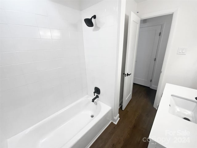 bathroom with vanity, tiled shower / bath combo, and hardwood / wood-style flooring