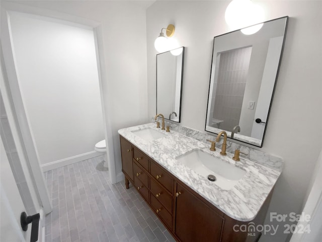 bathroom with tile patterned flooring, vanity, and toilet