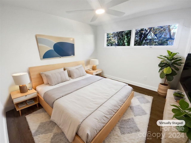 bedroom with hardwood / wood-style flooring, multiple windows, and ceiling fan