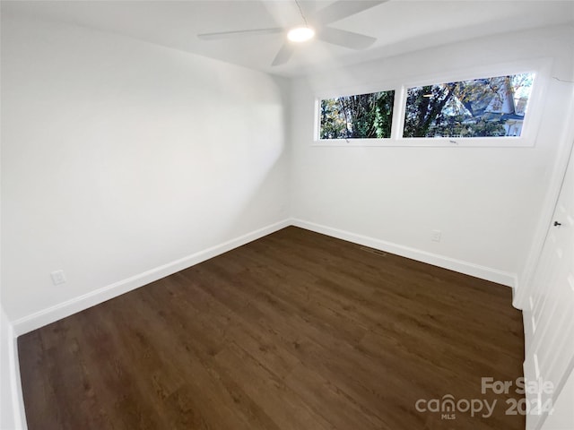 spare room featuring a wealth of natural light, dark hardwood / wood-style flooring, and ceiling fan