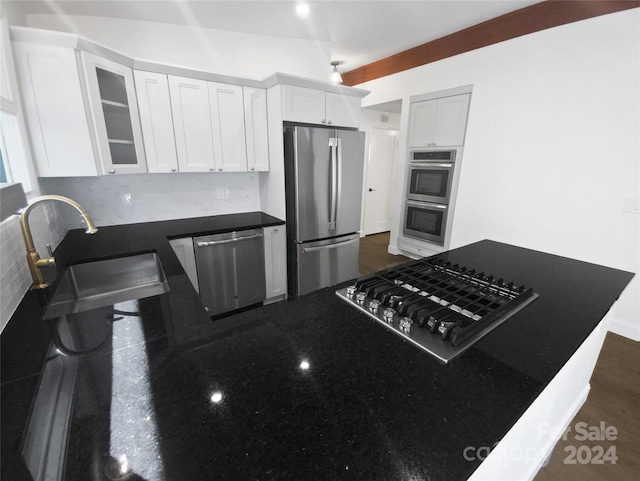 kitchen featuring white cabinetry, sink, tasteful backsplash, dark hardwood / wood-style flooring, and appliances with stainless steel finishes