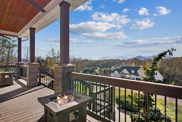 deck featuring a fire pit and a mountain view