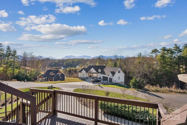 deck with a mountain view and a view of trees