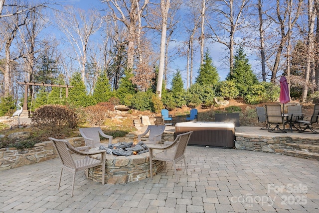 view of patio / terrace featuring an outdoor fire pit