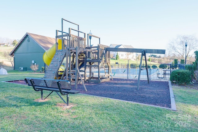 community jungle gym featuring a lawn