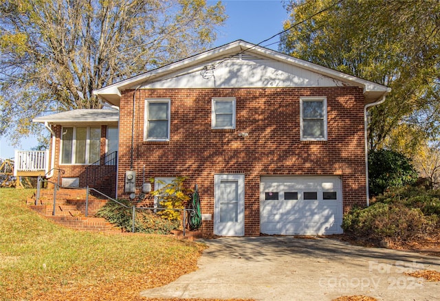 654 Meadowlark Dr, Winston Salem, NC 27106 - view of front of property featuring an attached garage, concrete driveway, brick siding, and a front yard