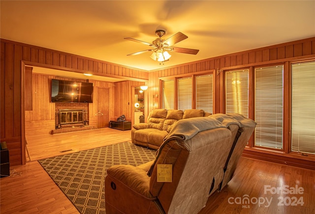 654 Meadowlark Dr, Winston Salem, NC 27106 - living room with ceiling fan, wood walls, hardwood / wood-style floors, and a brick fireplace