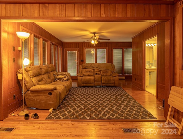 654 Meadowlark Dr, Winston Salem, NC 27106 - living room with wood walls, wood finished floors, and a ceiling fan