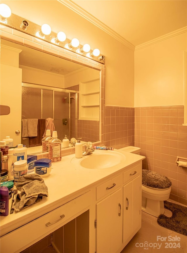 bathroom with a shower with door, crown molding, tile walls, tile patterned flooring, and toilet