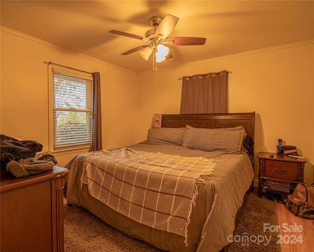 bedroom featuring carpet, ceiling fan, and ornamental molding