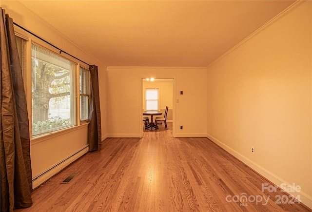 654 Meadowlark Dr, Winston Salem, NC 27106 - spare room with a baseboard radiator, wood finished floors, healthy amount of natural light, and crown molding