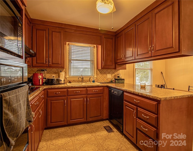 kitchen featuring black appliances, a healthy amount of sunlight, kitchen peninsula, and sink