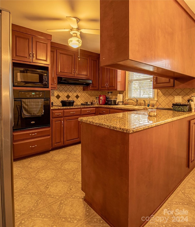 kitchen featuring black appliances, sink, decorative backsplash, light stone countertops, and kitchen peninsula