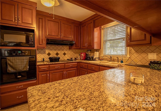 kitchen with black appliances, sink, decorative backsplash, ceiling fan, and light stone counters