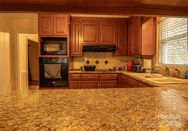 654 Meadowlark Dr, Winston Salem, NC 27106 - kitchen featuring black appliances, decorative backsplash, under cabinet range hood, crown molding, and light stone countertops