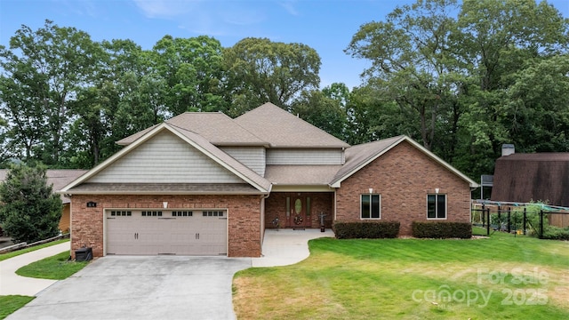 view of front of property with driveway, a front lawn, fence, an attached garage, and brick siding