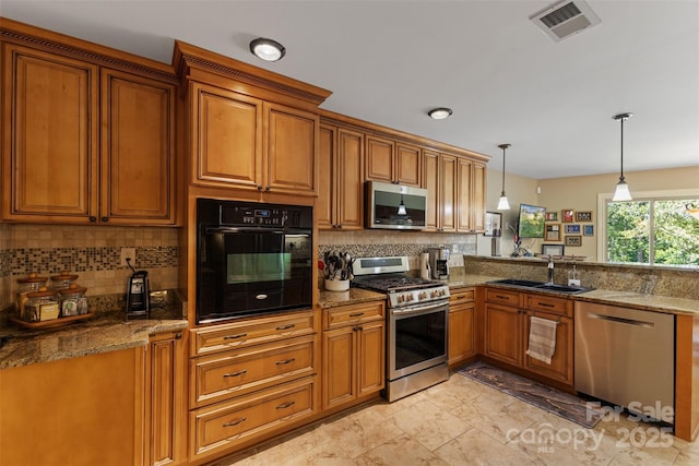 kitchen with a sink, brown cabinetry, visible vents, and stainless steel appliances